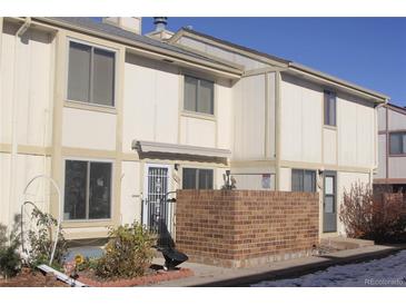 Exterior view of a townhouse with a brick patio at 10238 Quivas St, Thornton, CO 80260