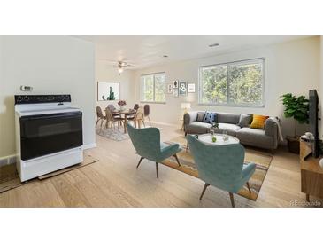 Bright living room with hardwood floors and modern furniture, featuring a dining area and comfy seating at 7902 Meade St # C10, Westminster, CO 80030