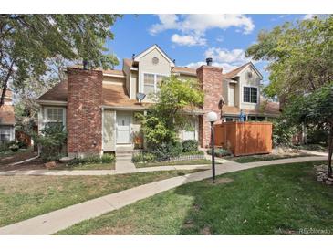 Brick townhouse with a small front yard and wooden fence at 12162 Bannock Cir # B, Denver, CO 80234