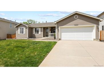 Ranch-style home with two-car garage and well-manicured lawn at 20709 E Hampden Pl, Aurora, CO 80013