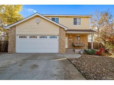 Two-story house with a two-car garage and landscaped yard at 13089 Alcott Pl, Broomfield, CO 80020