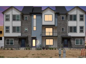 Modern three-story townhome with gray and white exterior at 14412 Pansy Loop, Morrison, CO 80465