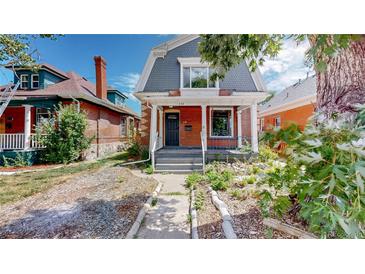 Brick home with front porch and landscaped yard at 638 S Lincoln St, Denver, CO 80209