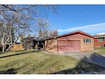 Ranch style home with brick exterior, attached garage, and spacious yard at 5001 E Iliff Ave, Denver, CO 80222