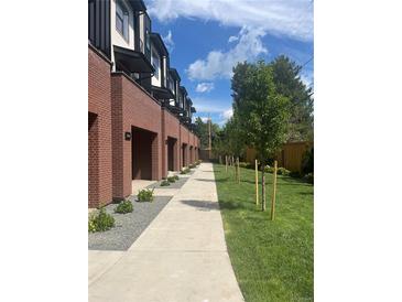 Exterior view of townhomes with brick facade and private walkway at 2164 Applewood Dr, Lakewood, CO 80215