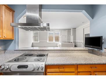 Modern kitchen featuring stainless steel appliances and granite countertops at 2351 Federal Blvd # 105, Denver, CO 80211