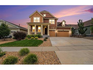 Two-story house with attached garage and front yard at 20052 W 95Th Pl, Arvada, CO 80007