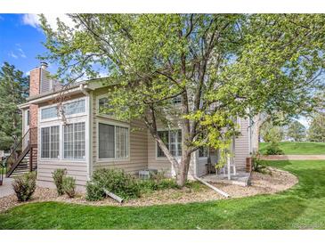 Rear exterior view showing a charming home with a landscaped yard at 13824 E Lehigh Ave # C, Aurora, CO 80014