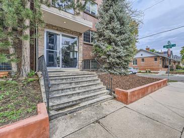 Exterior view of a residential building with steps and landscaping at 1 S Pennsylvania St # 102, Denver, CO 80209