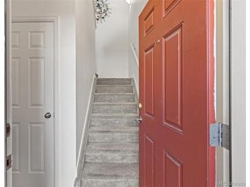 Carpeted staircase leading upstairs from the home's entryway at 9300 E Florida Ave # 607, Denver, CO 80247