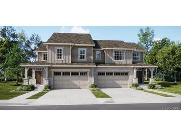 Two-story townhome with attached garage and attractive landscaping at 6699 Juniper Dr, Thornton, CO 80602