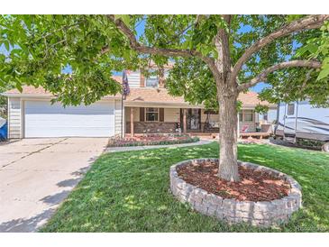 Ranch-style home with mature tree, double garage and circular driveway at 10021 Miller St, Broomfield, CO 80021