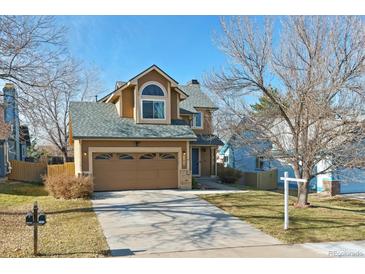 Two-story house with a two-car garage and landscaped yard at 11615 Masonville Dr, Parker, CO 80134
