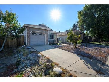 Ranch style home with a landscaped yard at 3074 S Uravan St, Aurora, CO 80013