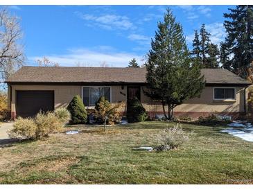 Ranch style home with a well-maintained lawn and mature trees at 370 Fulton St, Aurora, CO 80010