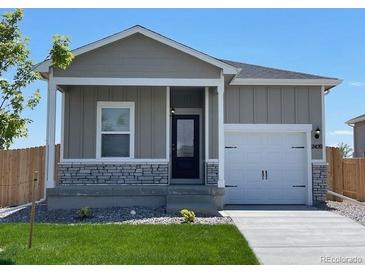 Charming house with gray siding, a white door, and a well-manicured lawn at 2420 Christina St, Fort Lupton, CO 80621
