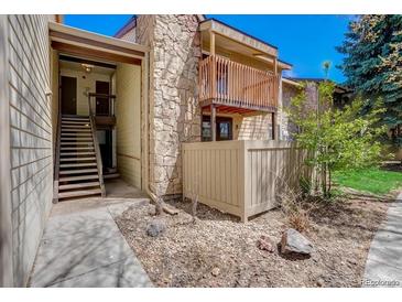 View of building exterior with stairs leading to unit entrance and patio at 7870 W 87Th Dr # J, Arvada, CO 80005