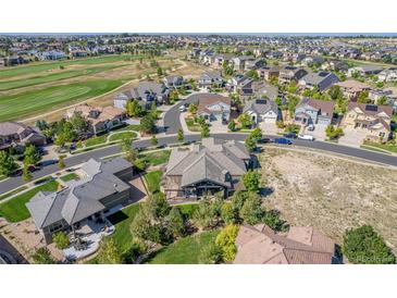 Aerial view of a luxury home community, showcasing a large house with a patio at 27365 E Jamison Cir, Aurora, CO 80016