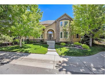 Two-story house with stone accents and manicured lawn at 21640 E Briarwood Dr, Aurora, CO 80016