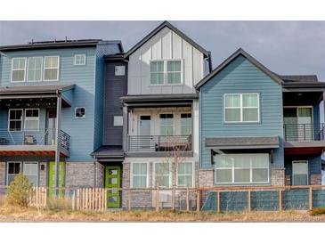 Contemporary three-story townhome with a charming front porch at 10334 Milwaukee Cir, Denver, CO 80229