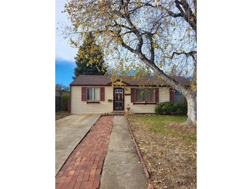 Ranch-style home with brick walkway and mature tree in front yard at 1709 Wabash St, Denver, CO 80220