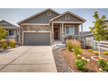 Gray siding, stone accents, and a landscaped front yard enhance this charming home's curb appeal at 4546 Cholla Trl, Castle Rock, CO 80104