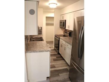 Modern kitchen with stainless steel appliances and granite countertops at 7615 E Quincy Ave # 101, Denver, CO 80237