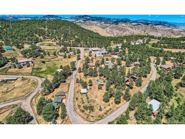 Aerial view of homes nestled in a mountain community with stunning views at 801 Panorama Dr, Golden, CO 80401