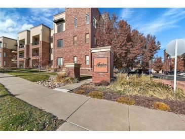 Brick building exterior with landscaping and a walkway at 301 Inverness Way # 209, Englewood, CO 80112