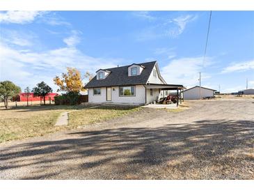 Ranch-style home with attached carport, large yard, and rural setting at 54686 E Bobcat Ln, Strasburg, CO 80136