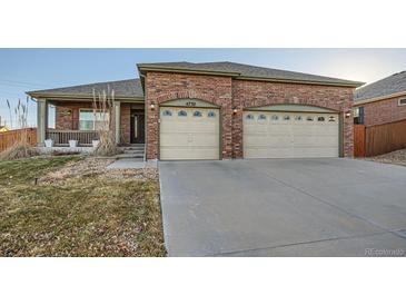 Brick ranch home with 2-car garage, landscaping, and a spacious front yard at 4732 S Coolidge St, Aurora, CO 80016