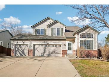 Two-story house with a three-car garage and landscaped yard at 1265 Button Rock Dr, Longmont, CO 80504