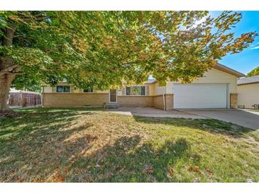 Ranch style home with attached garage and mature landscaping at 1340 Daphne St, Broomfield, CO 80020