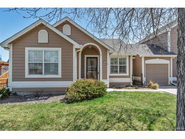 Tan one-story home with a two-car garage at 6428 Newcombe St # A, Arvada, CO 80004