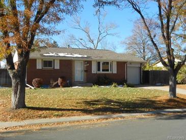 Brick ranch home with attached garage and mature trees at 12484 E Alaska Ave, Aurora, CO 80012