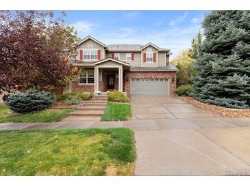 Two-story house with brick accents and a landscaped front yard at 2551 S Flanders Ct, Aurora, CO 80013