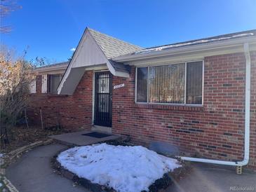 Brick ranch house with a neat front yard and walkway at 12226 E Ohio Ave, Aurora, CO 80012