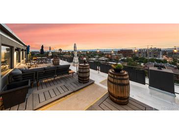 Private rooftop deck with city views and comfortable seating at 669 N Washington St # 901, Denver, CO 80203