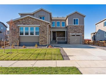 Two-story house with stone accents and a three-car garage at 1737 Marlowe E Cir, Erie, CO 80516