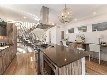 Modern kitchen with stainless steel appliances and an island at 2032 W 36Th Ave, Denver, CO 80211