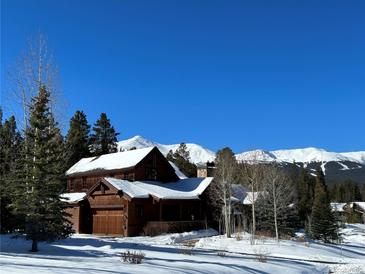 Mountain home exterior, snowy landscape, attached garage, and mountain views at 168 Corkscrew Dr, Breckenridge, CO 80424