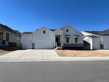 Two-story house with white siding, gray accents, and a two-car garage at 3801 Freestone Pt, Castle Rock, CO 80108