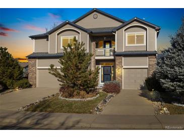 Inviting two-story home with a well-maintained front yard and attached two-car garage at 16815 Cedar Ridge Ct, Parker, CO 80134