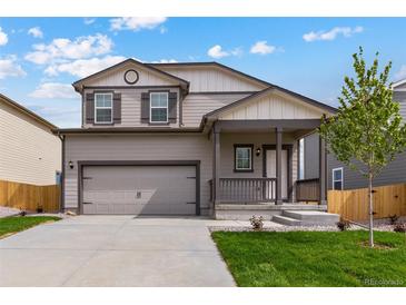 Two-story house with gray siding, attached garage, and landscaping at 7302 Arkansas Street, Frederick, CO 80530
