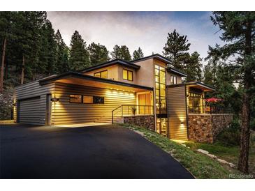 Stunning contemporary home with mountain views, expansive windows, and a spacious driveway at 32651 Buffalo Creek Rd, Evergreen, CO 80439