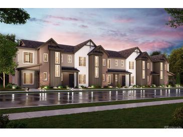 Modern townhome development with attached garages and landscaping at 458 Millwall Cir, Castle Pines, CO 80108