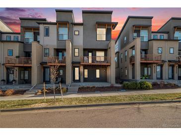 Modern townhouses with private balconies and landscaped yards at 10065 Town Ridge Ln, Lone Tree, CO 80124