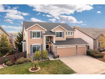 Two-story house with a three-car garage and landscaped yard at 10250 Dan Ct, Highlands Ranch, CO 80130