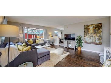 Bright and airy living room with hardwood floors and comfy sectional sofa at 28 W Broadmoor Dr, Littleton, CO 80120