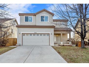 Two-story house with attached garage and landscaped yard at 5241 S Shawnee St, Aurora, CO 80015